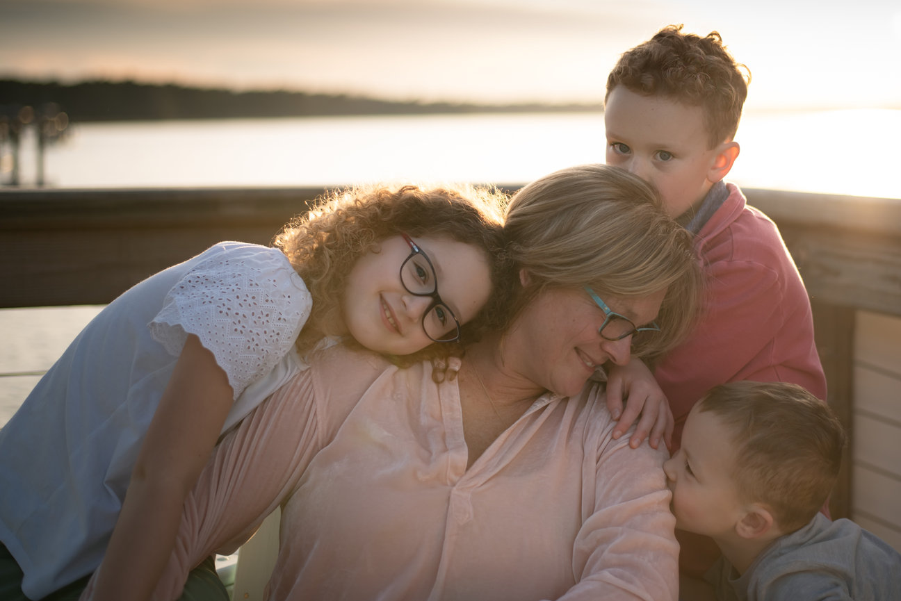 6 Steps on How to Get the Most Out of Your St. Louis Family Portrait Session grandma with grandkids by water at sunset