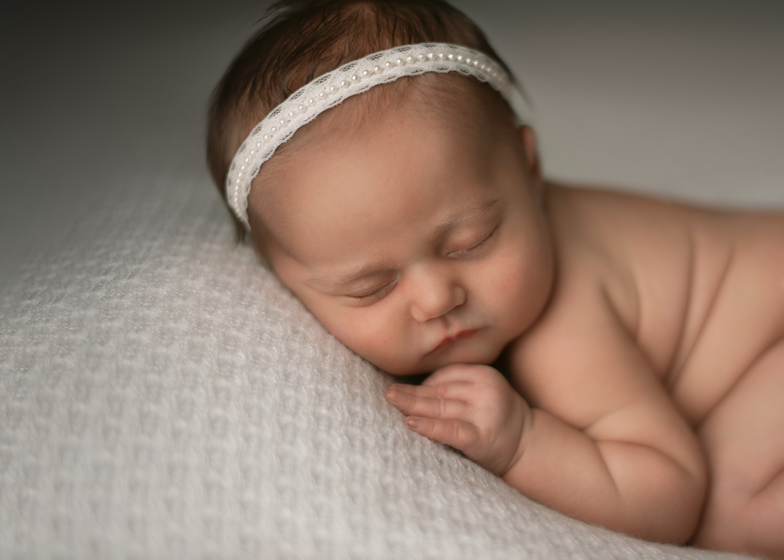 baby on white blanket with pearl headband ST.louis le leche league 